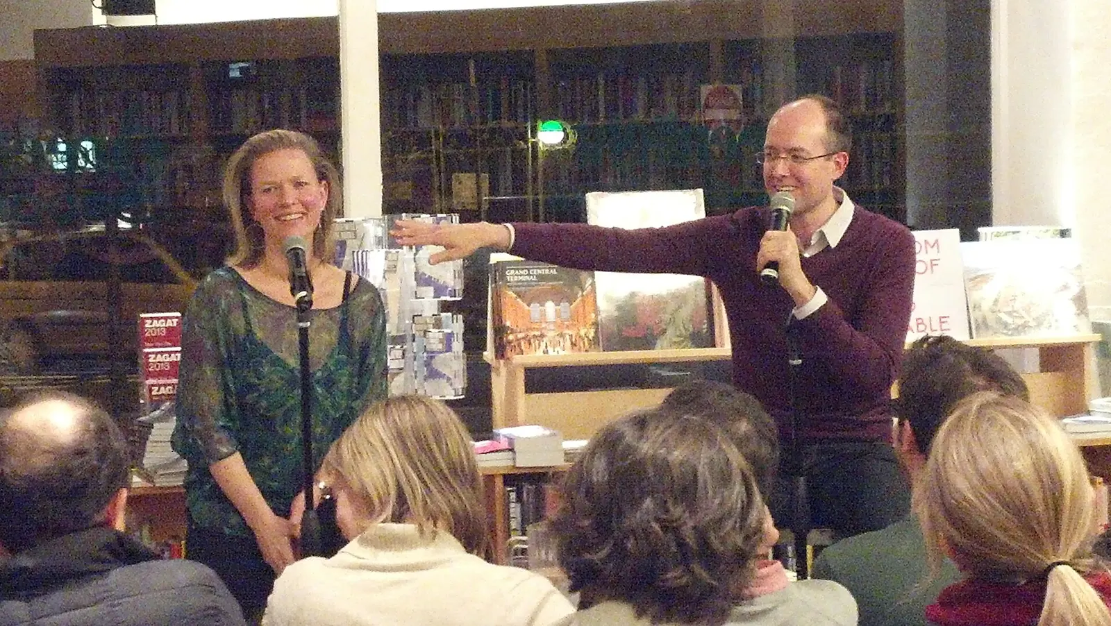 Two people talking together in a bookstore